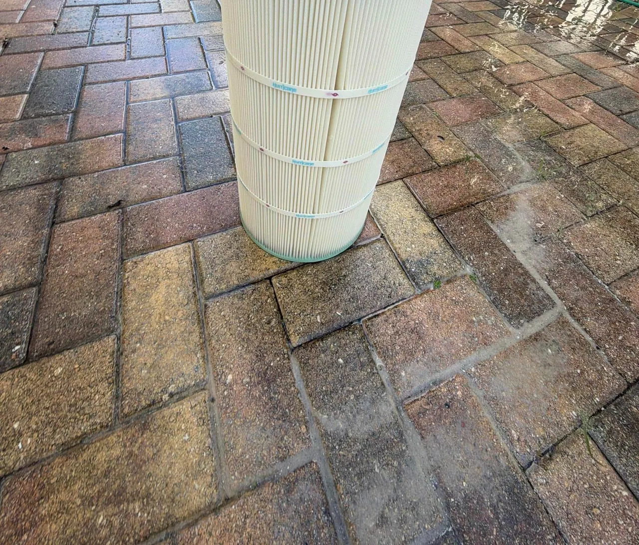 A pool cartridge filter after cleaning, bright white again
